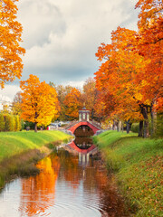 The Cross Bridge in autumn. Golden autumn in Catherine Park, Tsarskoye Selo. Old city park with...
