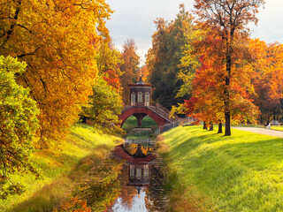 The Cross Bridge in autumn. Golden autumn in Catherine Park, Tsarskoye Selo. Old city park with...