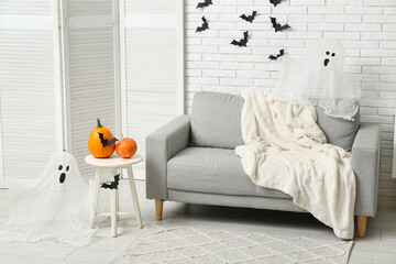Interior of living room decorated for Halloween with sofa and paper bats