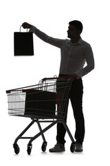 Silhouette of young man with bags and shopping cart on white background