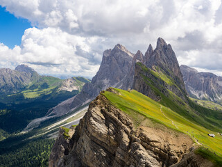 Seceda Panascharte in the Dolomites beautiful panorama with green gras and rocks, cloudy sky