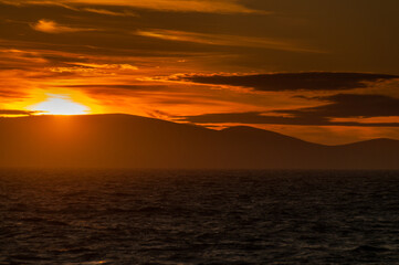 A dramatic sunset over the falkland islands, as seen from an antarctic expedition vessel.
