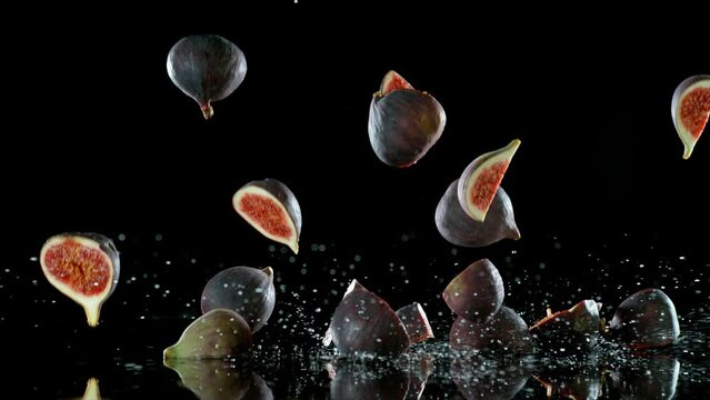 Super Slow Motion of Falling Figs Slices into Water on Black Background. Filmed on High Speed Cinema Camera, 1000 fps.