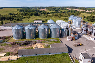 agro-processing and manufacturing plant for processing and silver silos for drying cleaning and storage of agricultural products, flour, cereals and grain. aerial view on granary elevator. - obrazy, fototapety, plakaty