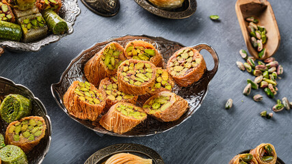 An image taken from above of a plate of Arabic sweets on a white background. Name of the item in Arabic: mabroma