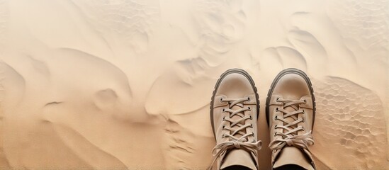 Snake skin patterned boots with lug soles on isolated pastel background Copy space with shoe lace
