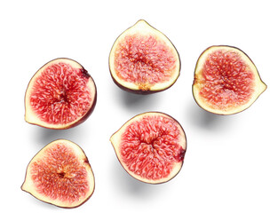 Halves of fresh ripe figs on white background