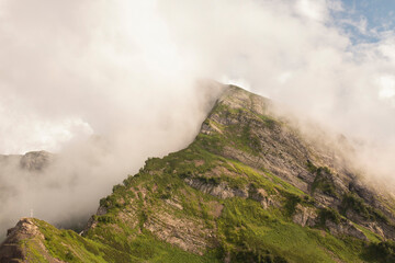 Thick clouds over the mountains on a sunny summer day