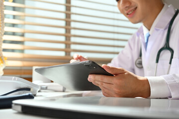 Fototapeta premium Close-up image of doctor using a digital tablet