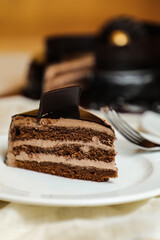 Black Forest Cake slice include chocolate chip, fork, sugar baked served in plate isolated on table side view bake cafe