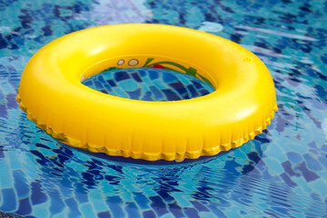 Swimming pool with yellow inflatable ring.