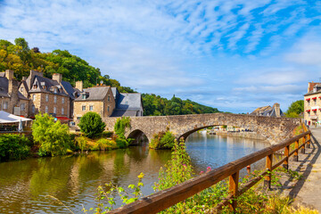 panoramic view of old stone bridge and historical medieval houses reflecting in La Rance river in Dinan town port