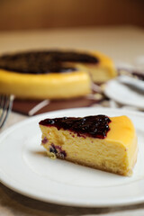 Blueberry Cheesecake slice include caramel with fork and knife served in plate isolated on table top view of cafe bake food