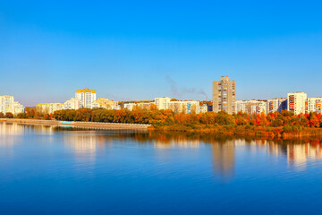 Fototapeta na wymiar Coastal city in the autumn . City houses along the riverbank. Rybnitsa is a town in Transnistria in Moldova