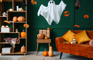 Interior of living room decorated for Halloween with sofa and pumpkins