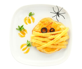 Plate with tasty Halloween mini pizza and spider on white background