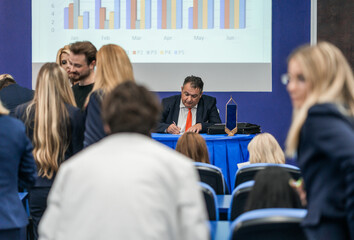 Adult colleagues attending business training in modern conference room, collaborating, sharing ideas, solving problems, ensuring company growth.