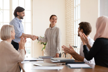 Concept of the best employee promotion, praising or monetary bonus. Boss shake hands with...