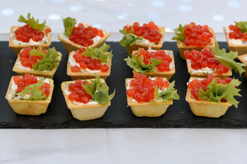 Tartlets with red caviar. Appetizers are delicious for a buffet.