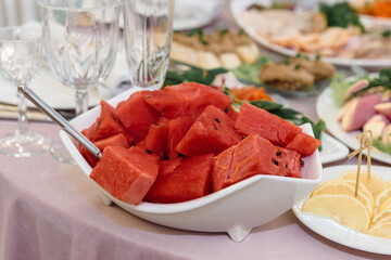 Watermelon red slices on a platter. Delicious berries for a banquet.