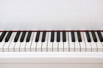 Black keys of a white piano. A musical instrument for classical music.