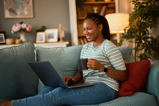 Happy African American Woman With Laptop And Coffee At Home