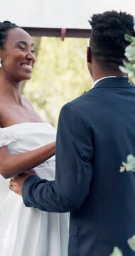 Happy black couple, wedding and kiss in marriage, commitment or support together at alter. Married African woman and man kissing in embrace, trust or relationship of bride or groom in outdoor romance