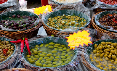 baskets full of olives of all kinds sizes and colors for sale in the market