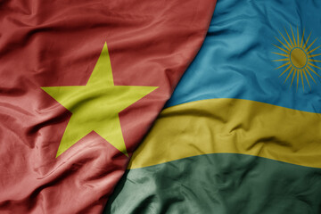 big waving realistic national colorful flag of vietnam and national flag of rwanda .