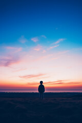 Obraz premium A child gazing at the horizon isolated on a dusk gradient background 