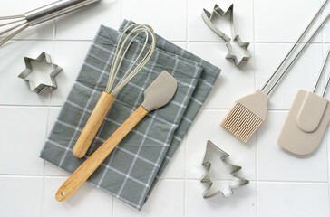 Flat lay of kitchen utensils on tile white background, top view