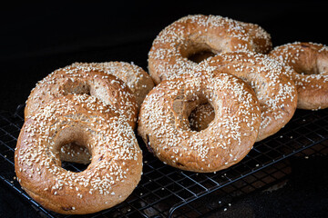 Bagel. Onion bagels sprinkled with sesame seeds close-up on a black background