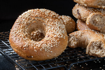 Bagel. Onion bagels sprinkled with sesame seeds close-up on a black background