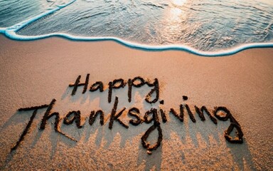 Happy Thanksgiving written on sandy beach concept. Holiday greeting concept. - obrazy, fototapety, plakaty