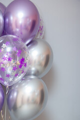 set of purple chrome balloons on wall background