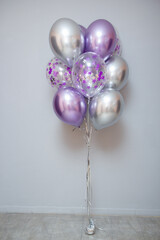 set of purple chrome balloons on wall background