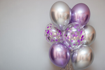 set of purple chrome balloons on wall background