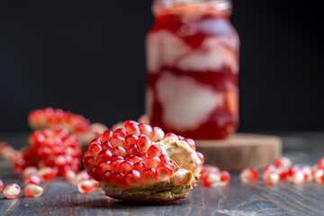 Red pomegranate seeds on the table and the board