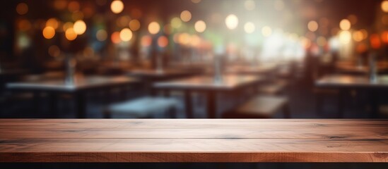 Fototapeta na wymiar Wood table top with blurred restaurant background for displaying or assembling products