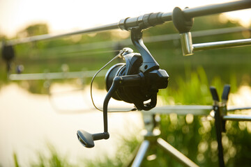 Fishings reel close-up on the background of the river, lake