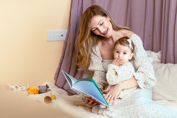 Young mom reading to her baby daughter