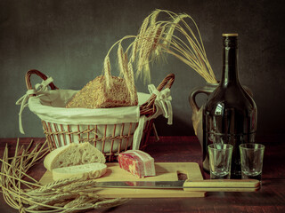 Rustic still life in antique style with bread, ears of wheat and ham and bacon. - 651622151