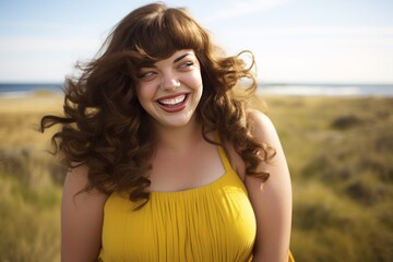 Studio portrait of Overweight woman in short yellow dress smiling