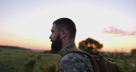 Tracking shot of a soldier walking towards his house on sunset, homecoming