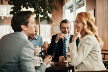 Diverse group of business colleagues having a conversation and enjoying coffee in a cafe decorated for christmas and the new year holidays