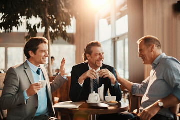 Middle aged business people having a meeting in a cafe decorated for christmas and the new year holidays