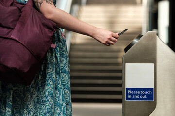 Unrecognizable woman holding card on card reader transport.