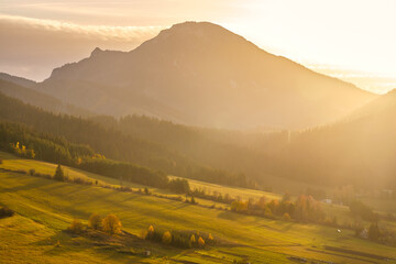 Naklejka na ściany i meble Autumn rural landscape with mountain at sunset. The Orava region of Slovakia, Europe.