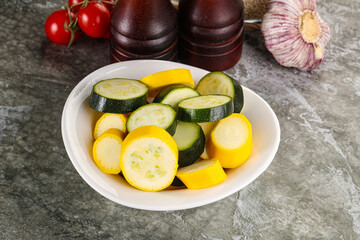 Sliced raw young green and yellow zucchini