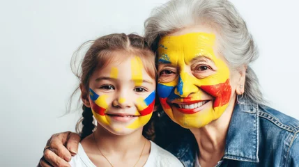 Foto op Canvas Colombian girl and grandmother paint the national flag on their faces © EmmaStock